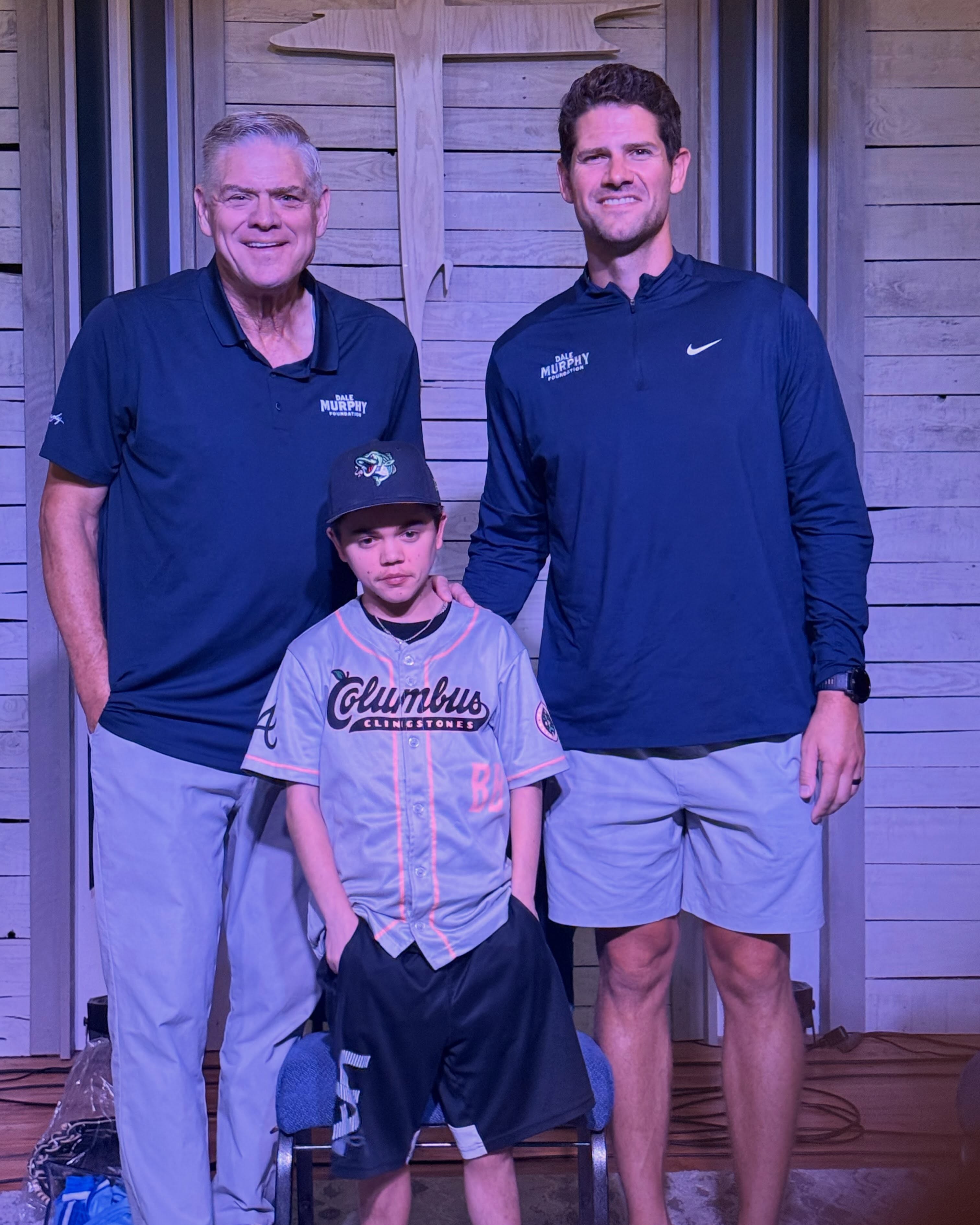 Dale Murphy and a Dale Murphy Foundation representative stand with Character Scholarship recipient Hunter Moore